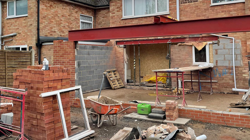 Builders completing home extension project with quality finish work